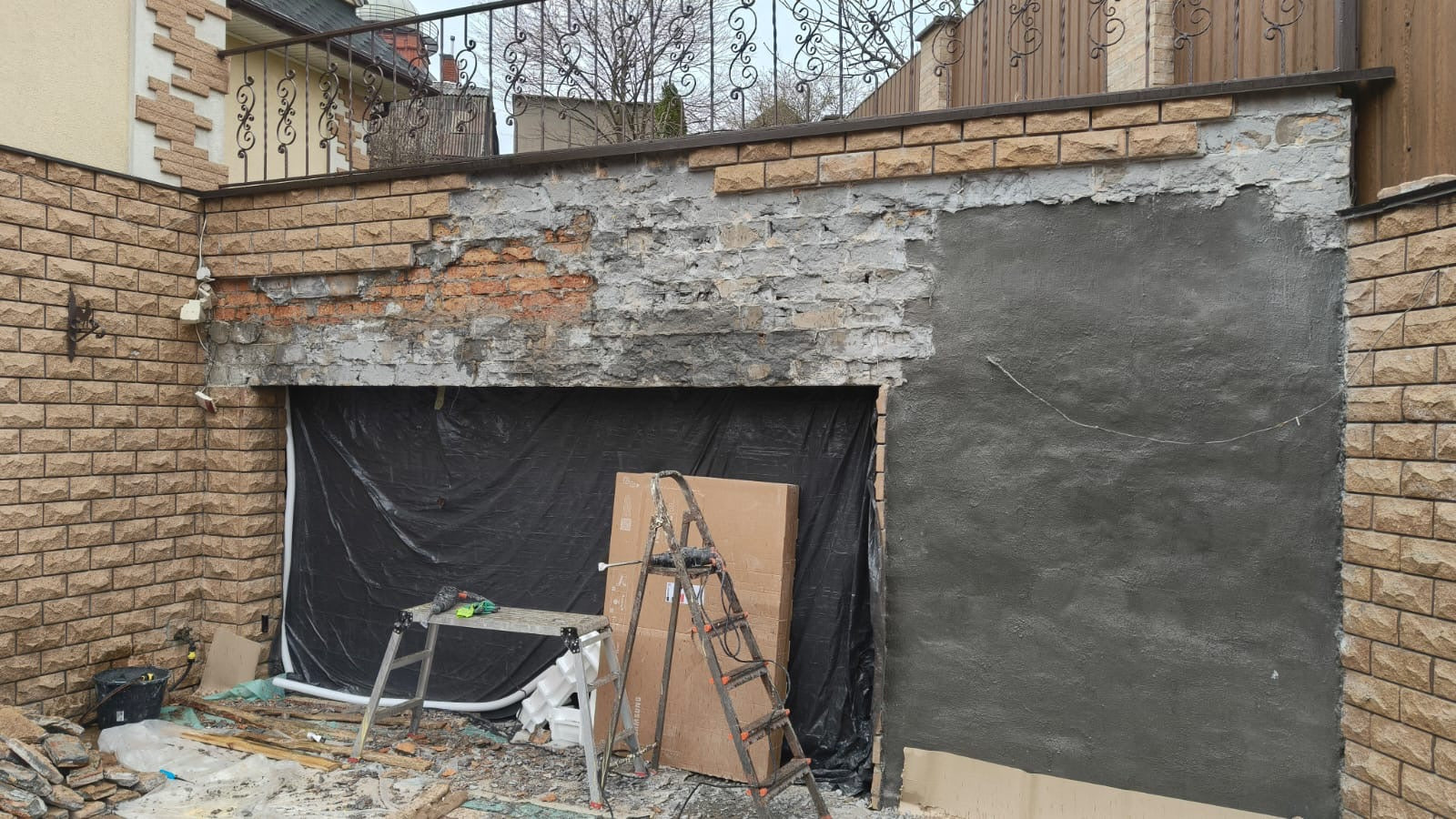 Before: damaged crumbling garage wall needing concrete repair